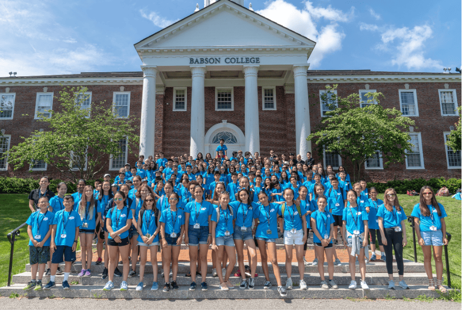 Group of Babson College students in front of the campus building