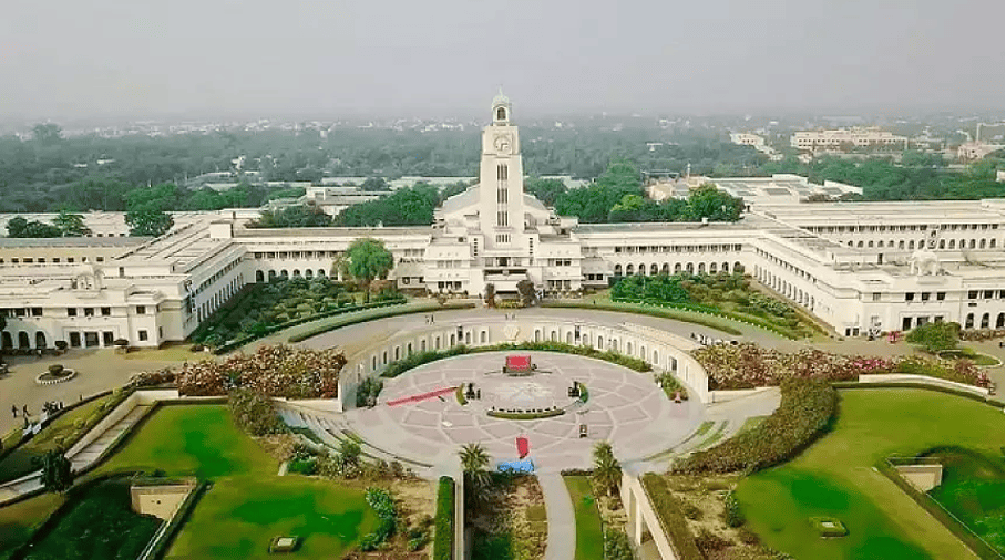 Aerial view of the expansive BITSOM campus, showcasing a grand central building surrounded by greenery and architectural beauty.