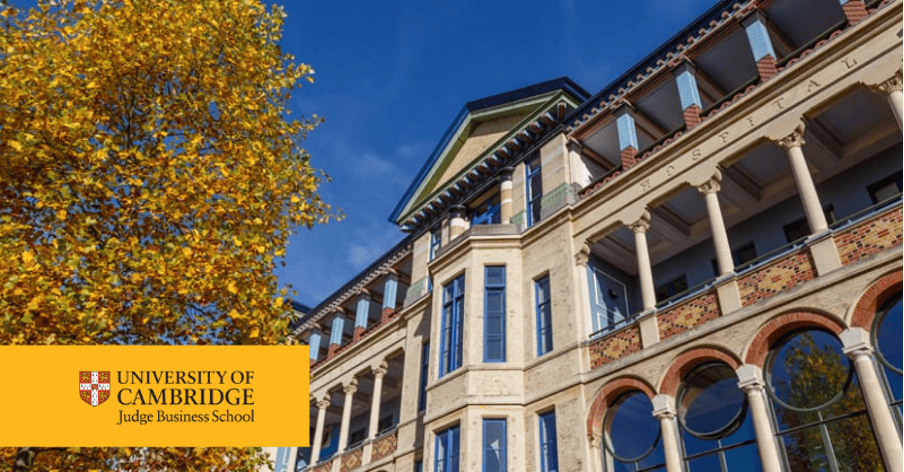 Historic building facade of Cambridge Judge Business School during autumn