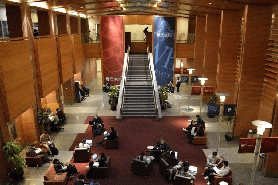 Students engaging in the Wharton School's spacious common area